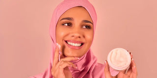 woman applying cream on her face