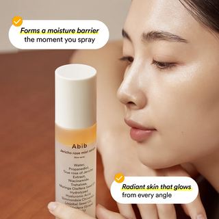 woman looking at Abib Jericho Rose Mist Serum Glow Spray bottle