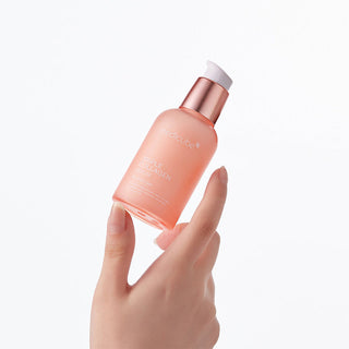 hand holding medicube Triple Collagen Serum bottle