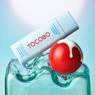 TOCOBO Bio Watery Sun Cream with a red ball on a jelly surface
