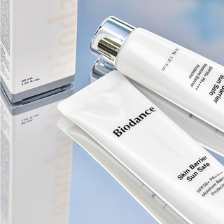 BIODANCE Sun Safe Skin Barrier SPF50+ PA++++ 30 mL products placed on a glass surface