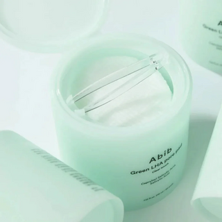 Abib Green LHA Pore Pads in a jar with a mini tong