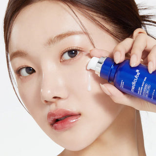 woman applying Medicube Zero Pore One-Day Serum on her cheek