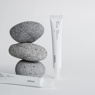 Two tubes of celimax eye cream with three gray stones