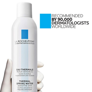 a hand holding LA ROCHE-POSAY Thermal Spring Water 150 g bottle