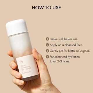 hand holding Dr.Ceuracle Vegan Kombucha Tea Essence bottle