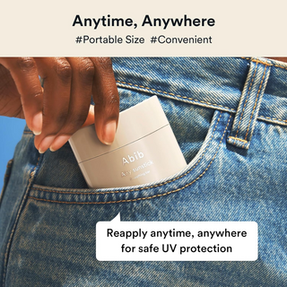 a hand putting Abib Airy Sunstick Smoothing Bar in pocket