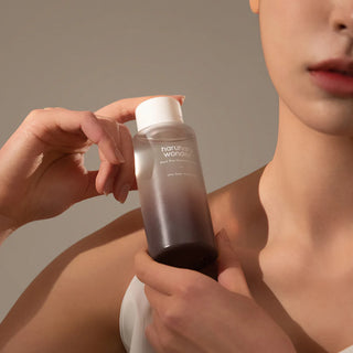 close-up of a woman holding haruharu wonder Black Rice Hyaluronic Toner