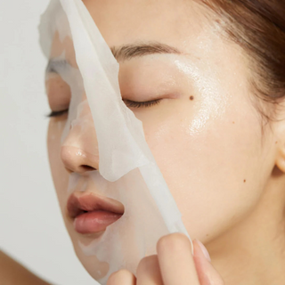 woman removing medicube Deep Peptide Radiance Mask from her face