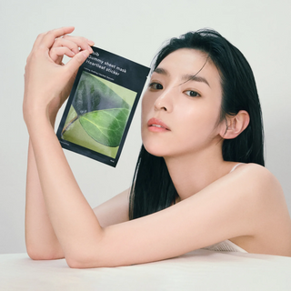 woman holding Abib Gummy Sheet Mask Heartleaf Sticker