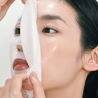 close-up of a woman applying Abib Gummy Sheet Mask.