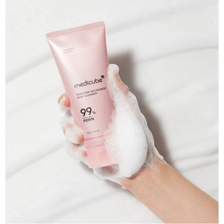 foamy hand holding Medicube PDRN Pink Niacinamide Whip Cleanser