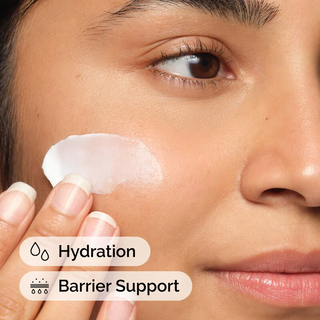 woman applying The Ordinary Natural Moisturizing Factors + HA on her cheek