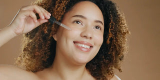 woman applying serum on her face