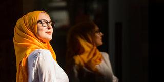 woman with glasses smiling