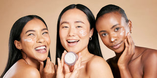 women with different skin tones smiling