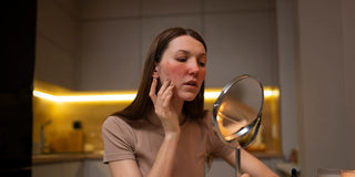 woman with damaged skin looking in the mirror