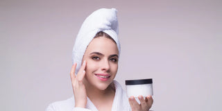 woman using moisturizer on her face